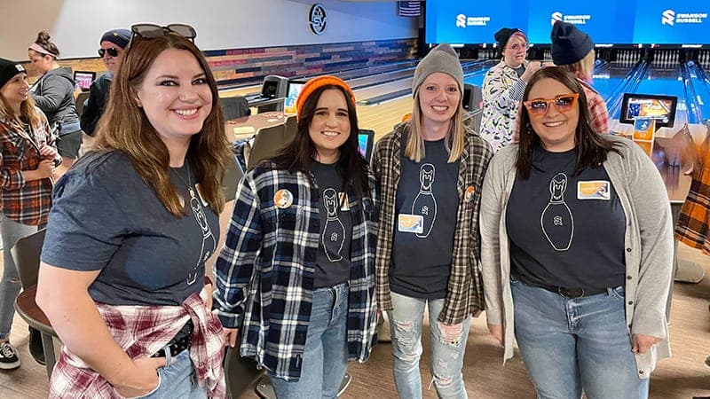 Four employees at a bowling alley for Swanapaloozabowlacon