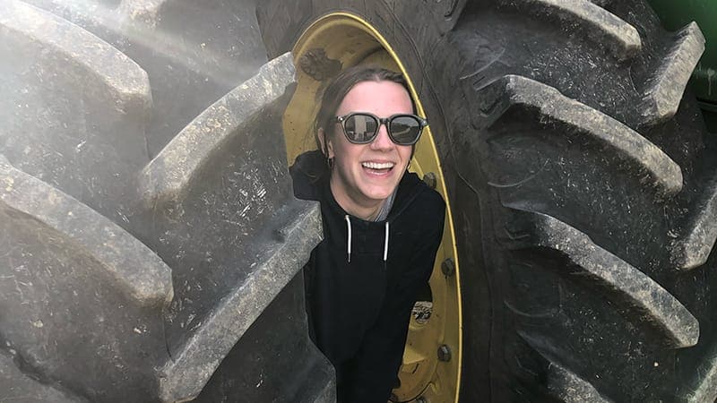 Margaret between two tractor tires