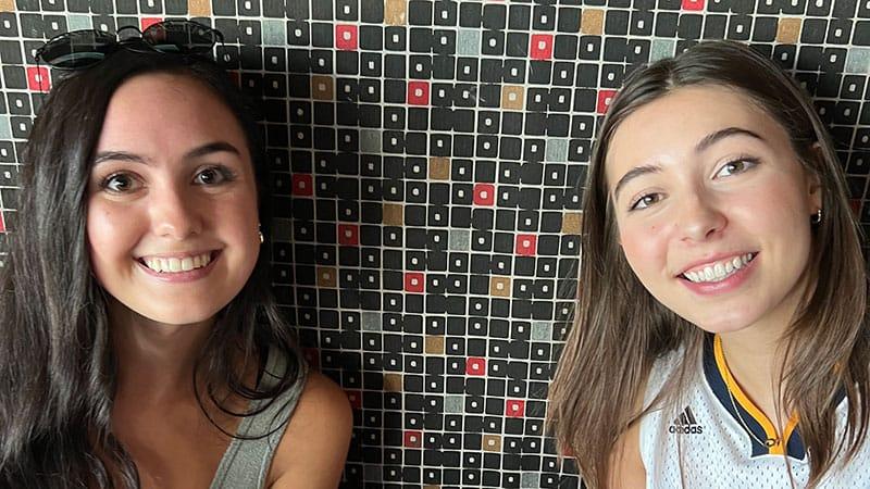 Two smiling employees in a booth
