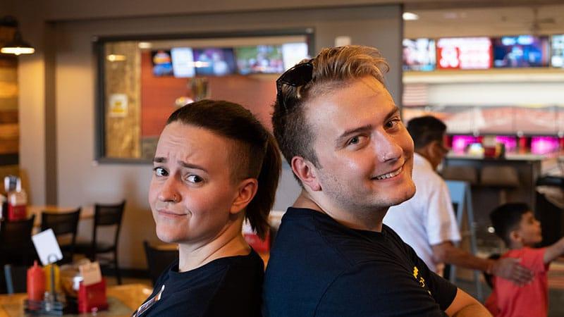 2 employees standing back to back
