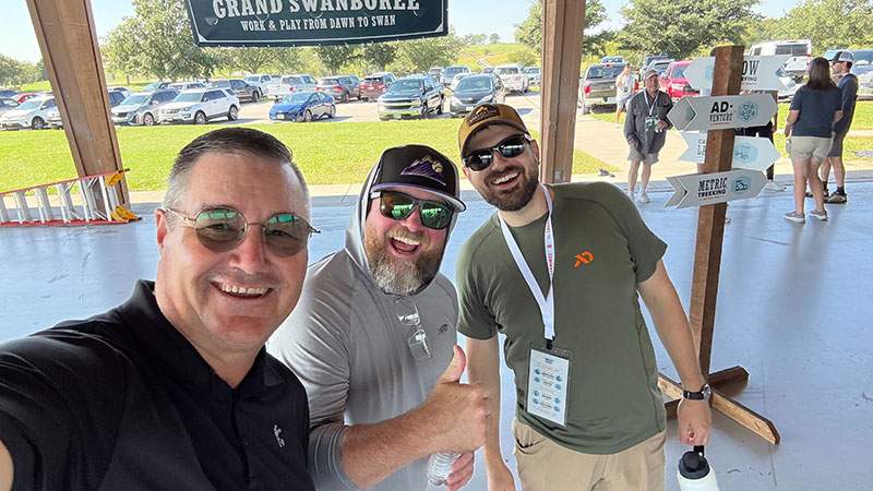 Three employees taking a smiling selfie at Grand Swanboree
