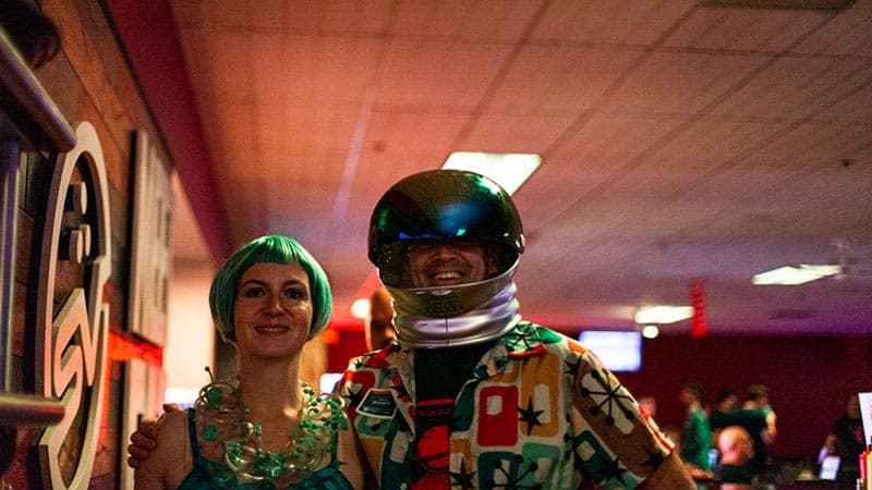 Employees dressed in space costumes at bowlapalooza