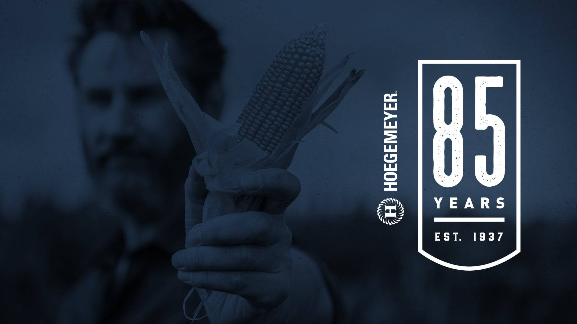Hoegemeyer 85 years poster with man holding corn
