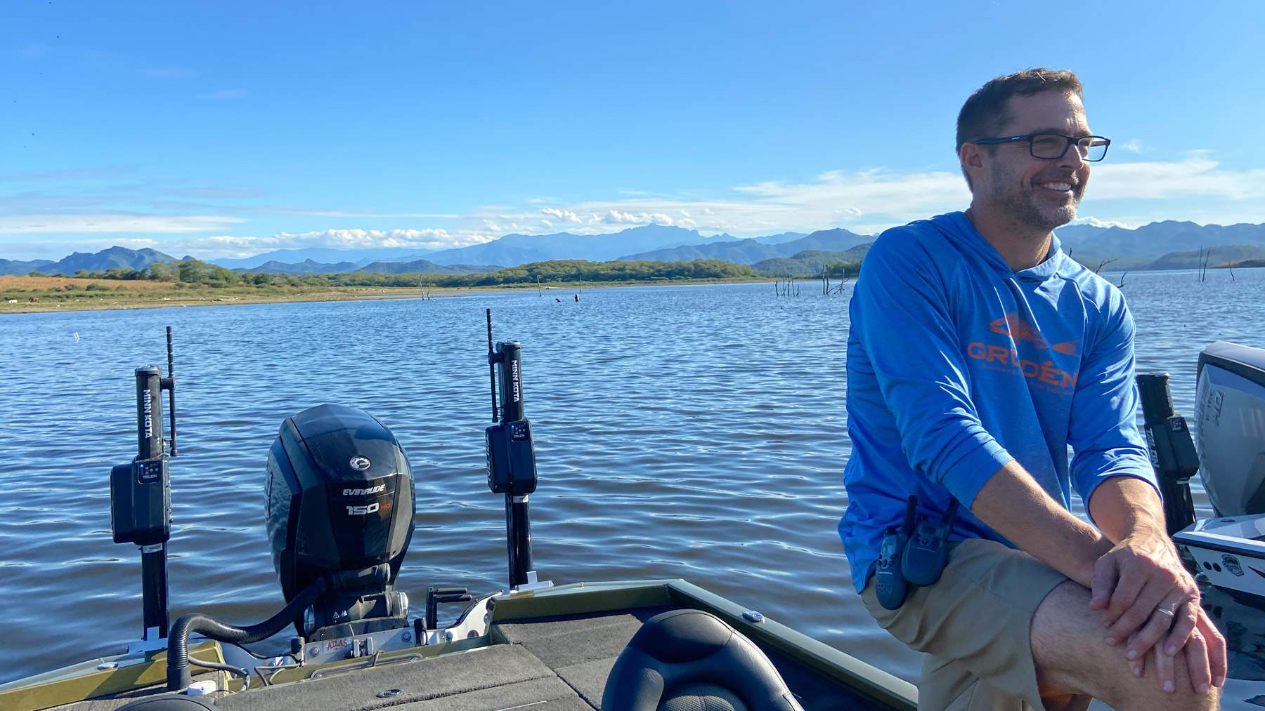 Man sitting on a boat during a client photoshoot.