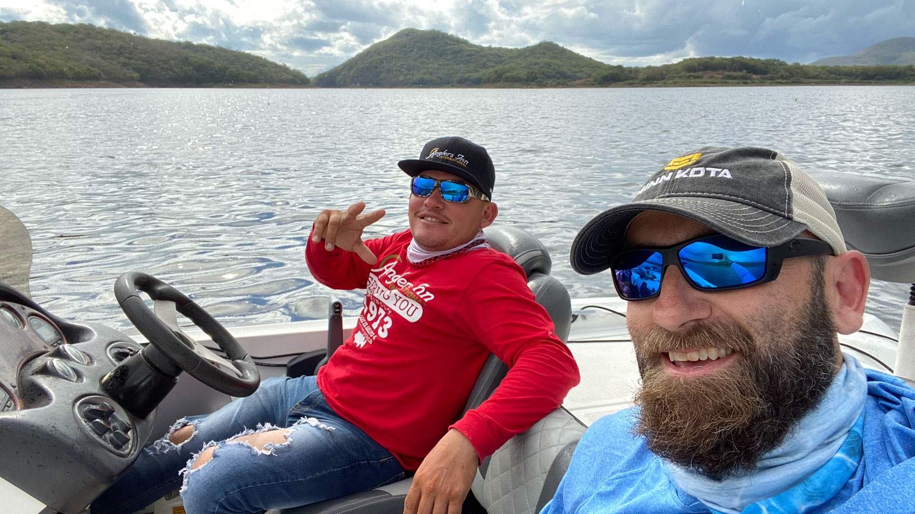 Two men on a boat out for a fishing trip.