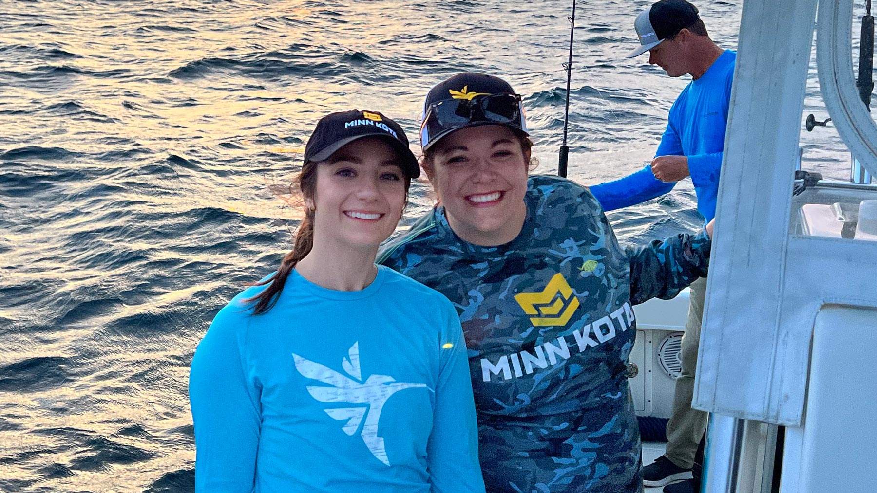 Two women on a boat during a client fishing photoshoot.