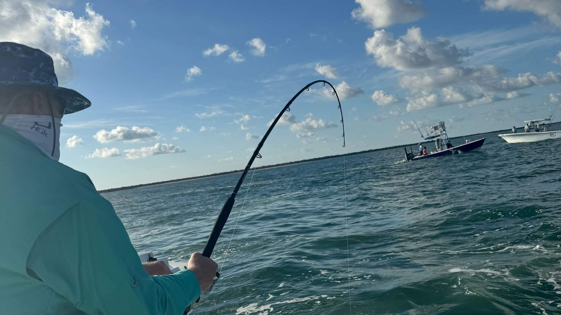Man fishing from a boat on a fishing trip.