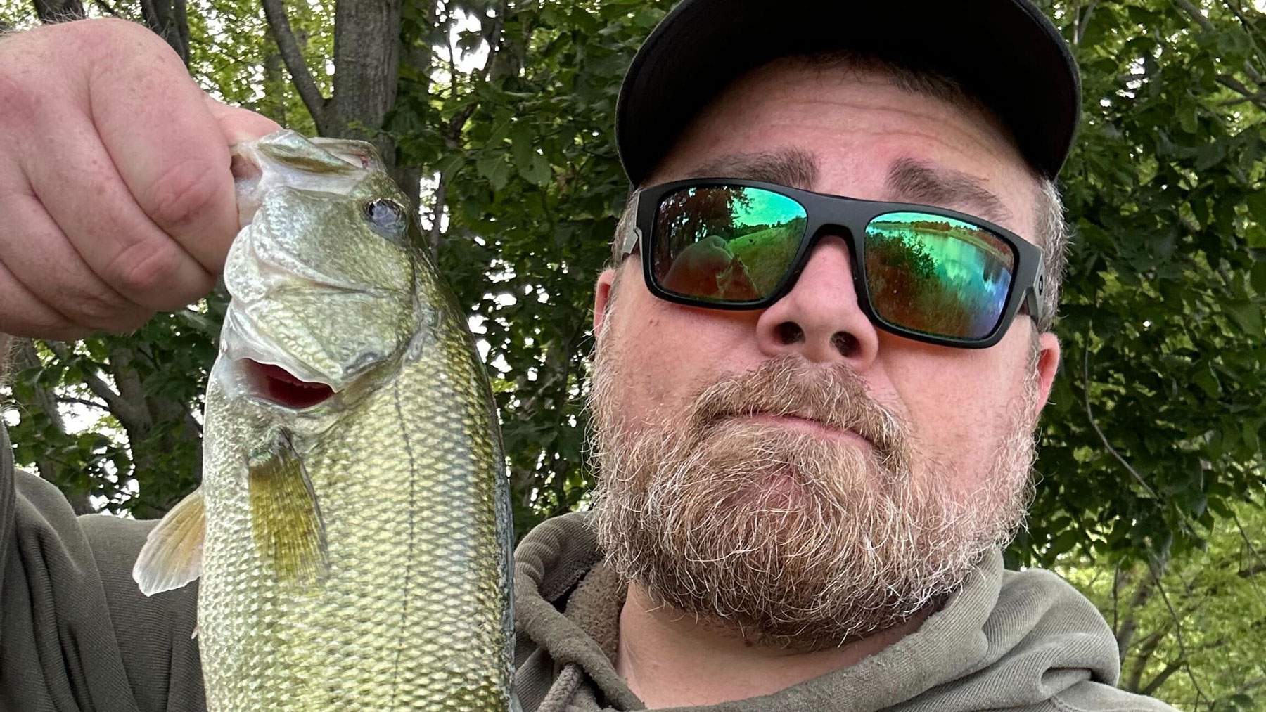 Man holding freshly caught fish.