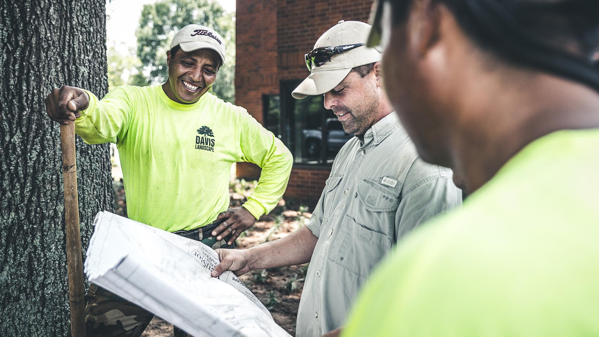 Men looking at landscaping plans